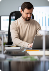 Image of a man working on his laptop