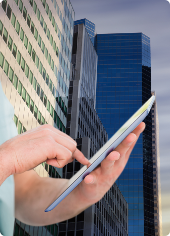 Image of a person viewing homes for sale on the tablet with some real estate buildings in the background